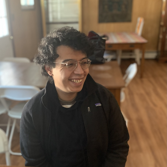 John R. Molina smiling in a sunlit room